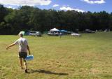 Bill Ridgely carries a block of ice to his campsite