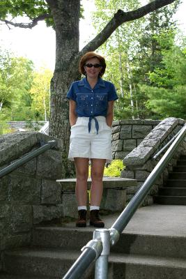 Charlotte on the stairs in front of the Visitor Center of Acadia National Park in Hull's Cove, Maine.