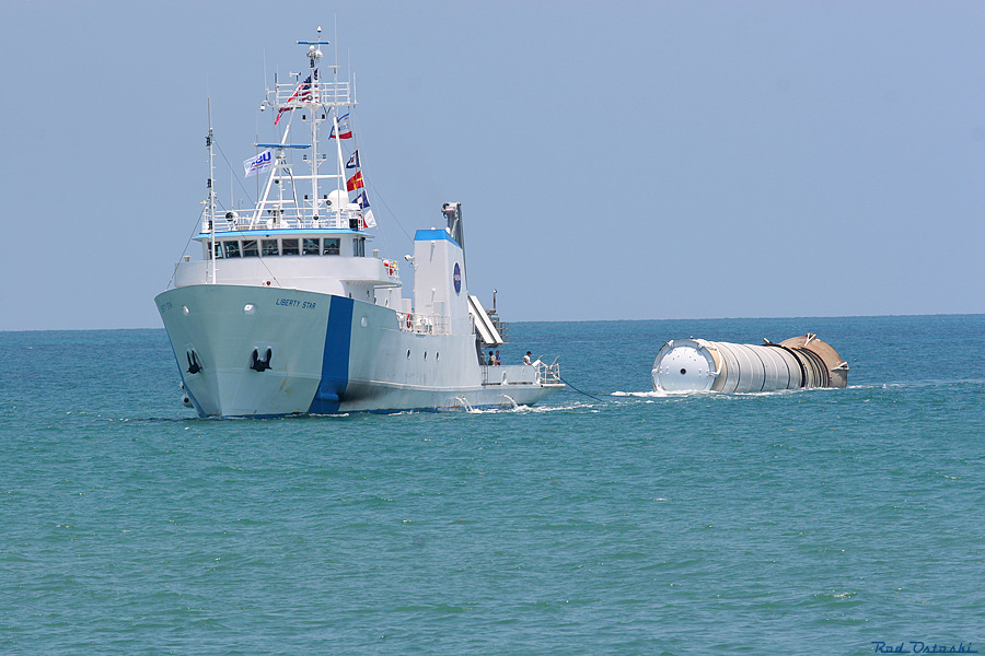 Liberty Star with retrieved SRB in tow