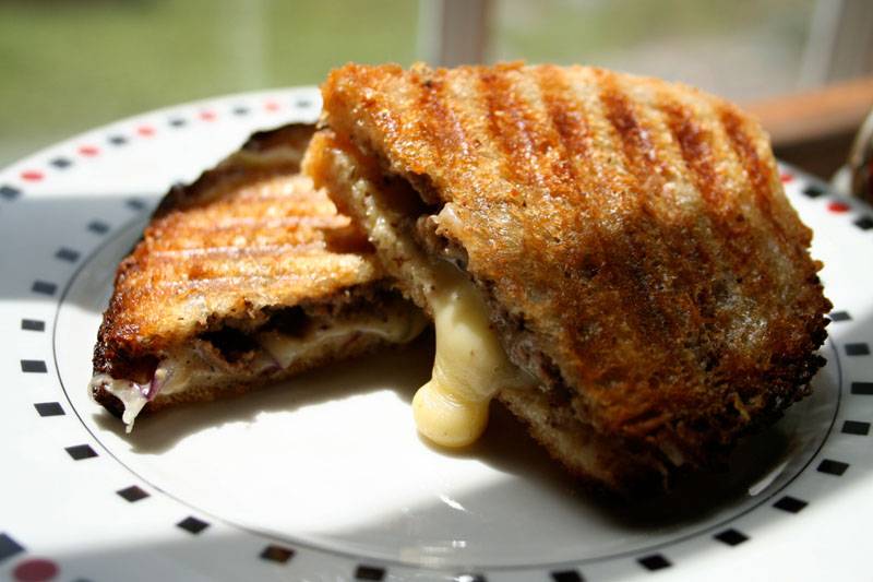 A liverwurst, mustard, onion, and Morbier panini