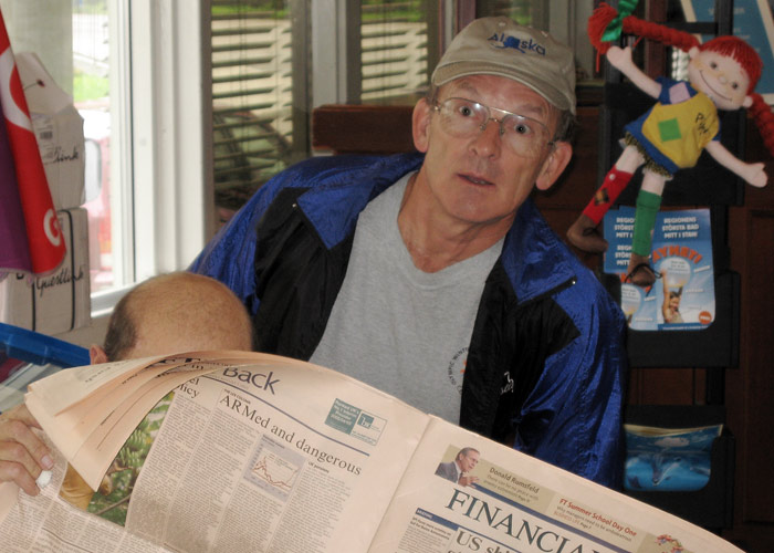 Bob reads the paper over Clives shoulder