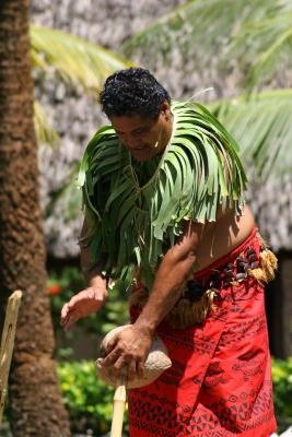 Samoan Man - Husking the coconut.
