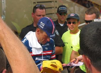 Lance Armstrong signs autographs