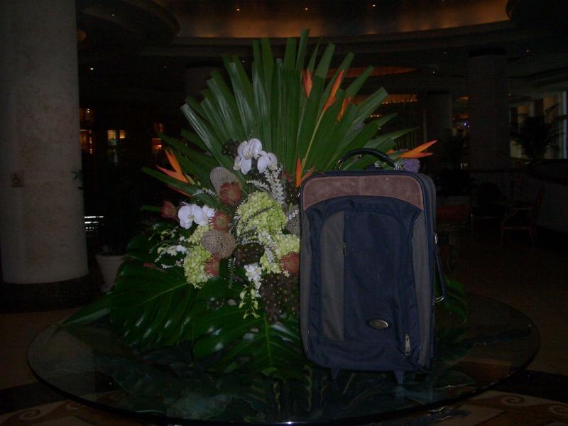 Suitcase enjoying the floral arrangement
