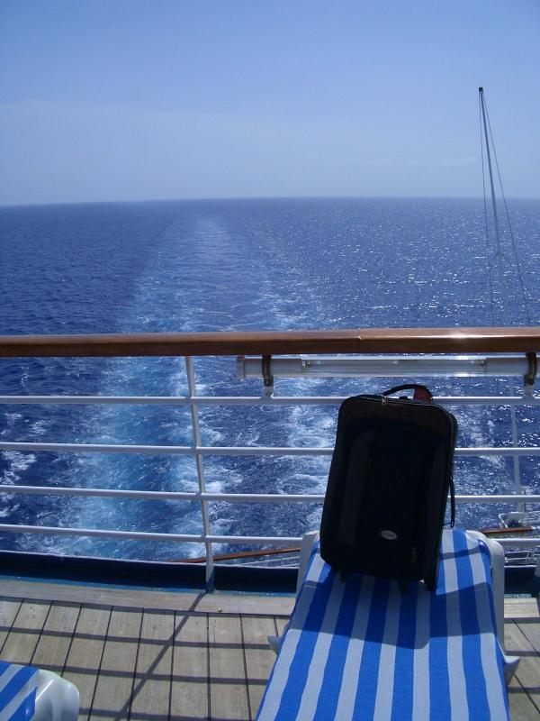 Suitcase posing by the back of the boat