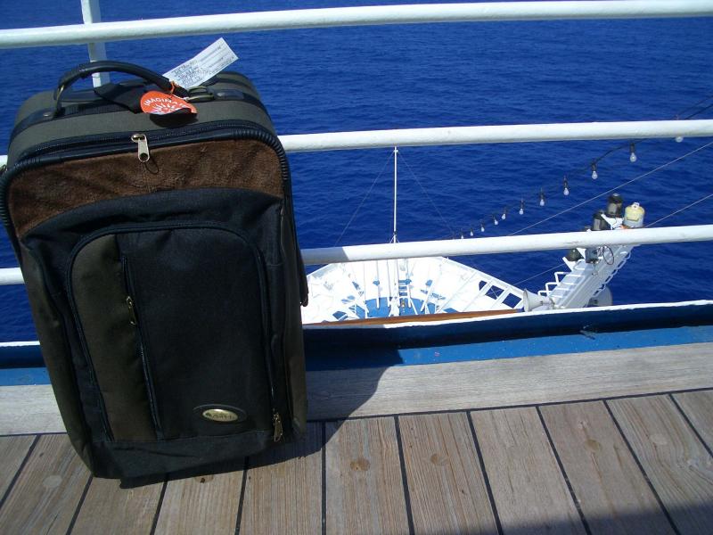 Suitcase posing by the front of the boat