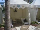 Suitcase finds a litle shade in a poolside cabana