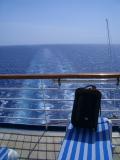 Suitcase posing by the back of the boat