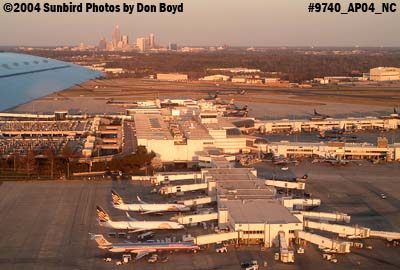 Charlotte Douglas International Airport at sunset with downtown Charlotte in the background aviation stock photo #9702
