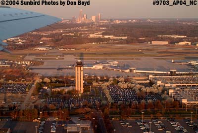 Charlotte Douglas International Airport at sunset with downtown Charlotte in the background aviation stock photo #9703