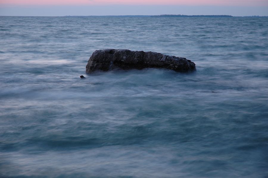 Waves breaking over a large rock