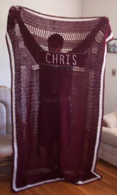 A surprise personalized Christmas present to Chris (shown here holding it up).  Both boys' blankets fit the top of a twin-sized bed.  Chris is a Texas Aggie fan, hence the color scheme of his blanket.