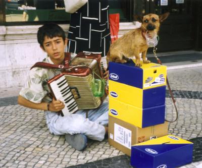 Boy with dog performing for escudos.jpg