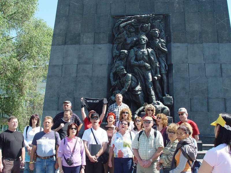 An Israeli tour group singing in front of the Ghetto Heroes Monument
