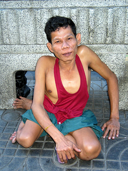 This disabled man is a street beggar on Sukhumvit.