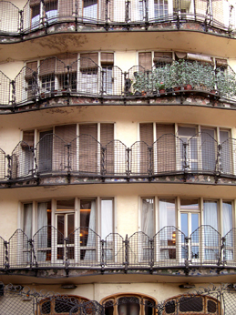 Gaud's Casa Batli: The rear facade from the rear courtyard.  Net-type design of railings.