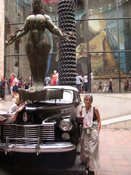Judy in the inner courtyard of the Dal Theater/Museum next to the Rainy Taxi, and the Queen Esther sculpture by Ernst Fuchs.