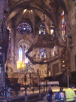 Cathedral: Baldachin (canopy) - lights & multicolored crucifix over altar by Gaud who modernized the interior, early 1900's.