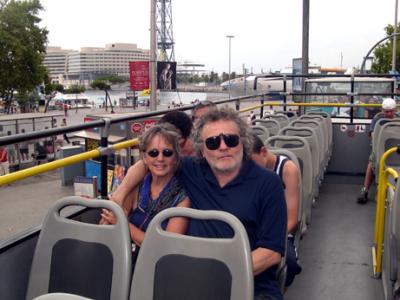 Judy and Richard on a bus touring Barcelona near the waterfront.