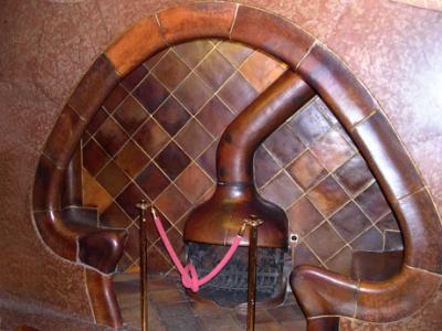 Gaud's Casa Batli: A fireplace with built-in benches nearby - in a small room on the main floor.