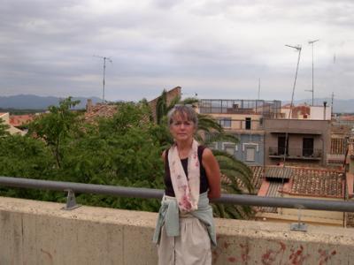 Judy in Figueres - just arrived by bus. Pyrenees Mountains in the background. (They separate the Iberian Peninsula from France).