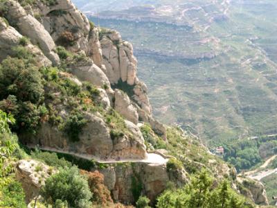Bicyclists heading up the mountain to the monastery. Taken from near the monastery (Monestir de Montserrat).