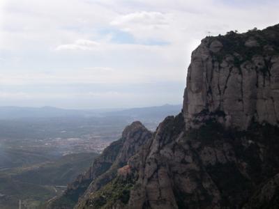 Montserrat (meaning serrated mountain) and the cross (seen at the top of the mountain) at the Chapel of Sant Miquel.