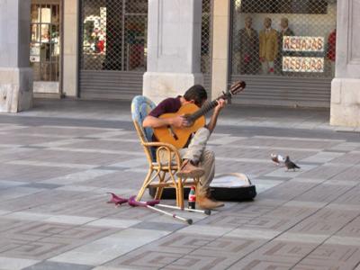 Flamenco guitarist caressing his guitar while playing. We could feel it in his music. While we ate dinner on Plaa Major.