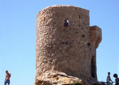 Judy looking out from the Ses Ąnimes watchtower. Watchtower used to defend the coast and nearby town from incursions by pirates.