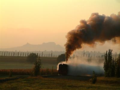 The rosy light catches the steam and smoke