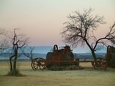 Antique machinery awaits the winter dawn.