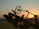 An antique plough silhouetted.