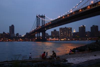 Children play under the Manhattan bridge