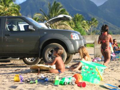 Hawaiian surfer kids waxing up
