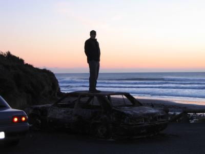 burned car at sunset (c examines)