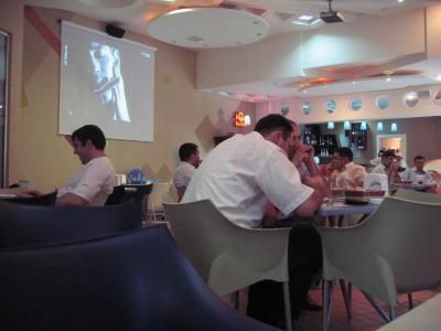 Projection tv inside Cafe Ekspress that shows Turkish music videos.