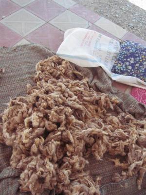 One of five big piles of raw wool on the front porch of the school.  This is the dowry for the director's daughter.
