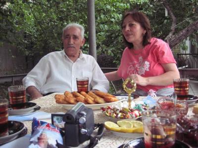 Natavan's grandfather and mother enjoy the repast.