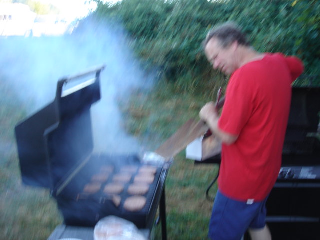 Tony turning the burgers with extra large spatula.  281.jpg
