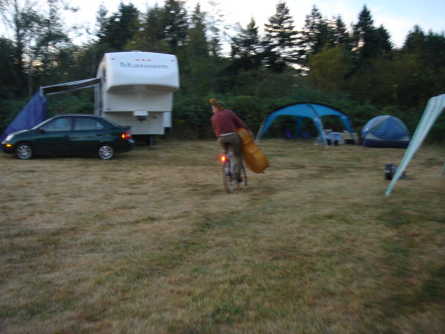 Tony Mates carries his bass while riding his bike.  352.jpg