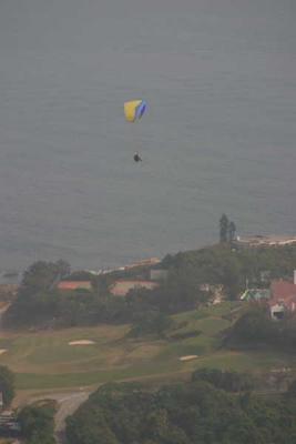 Paraglider over golf course