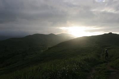 Jane heading toward the setting sun on the trail to Tai Mo Shan