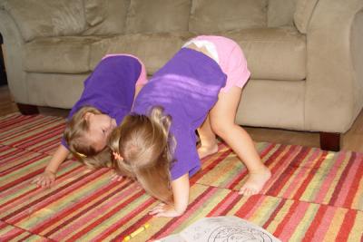 Giggling at each other in downward dog