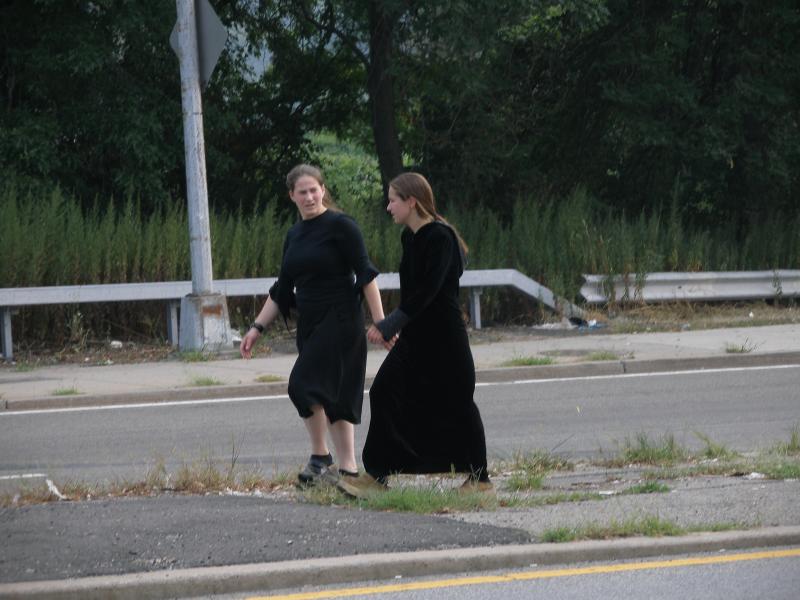 Two Young Women Wearing Black Dresses in 100F