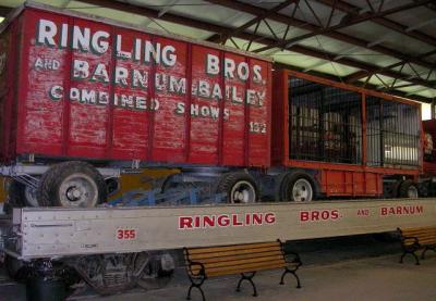 Ringling Bros. & Barnum & Bailey baggage wagon and cage wagon on flat car. ca 1950.