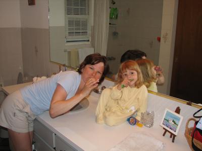 Brushing their teeth.