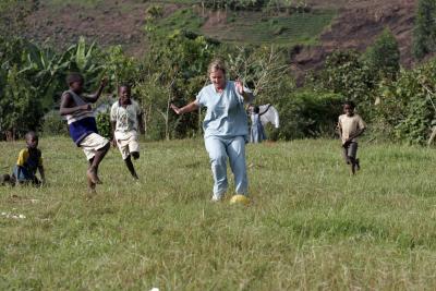 Heidi plays football with the local kids