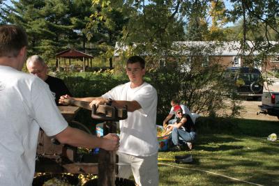 Daniel taking a turn at pressing apples