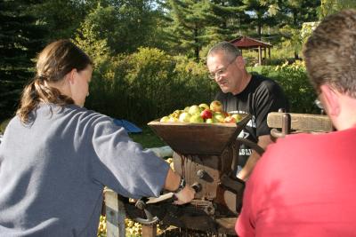 Alli and Bill grinding apples
