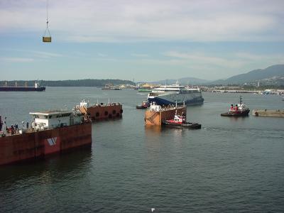 Tugs move in to position the vessel.
